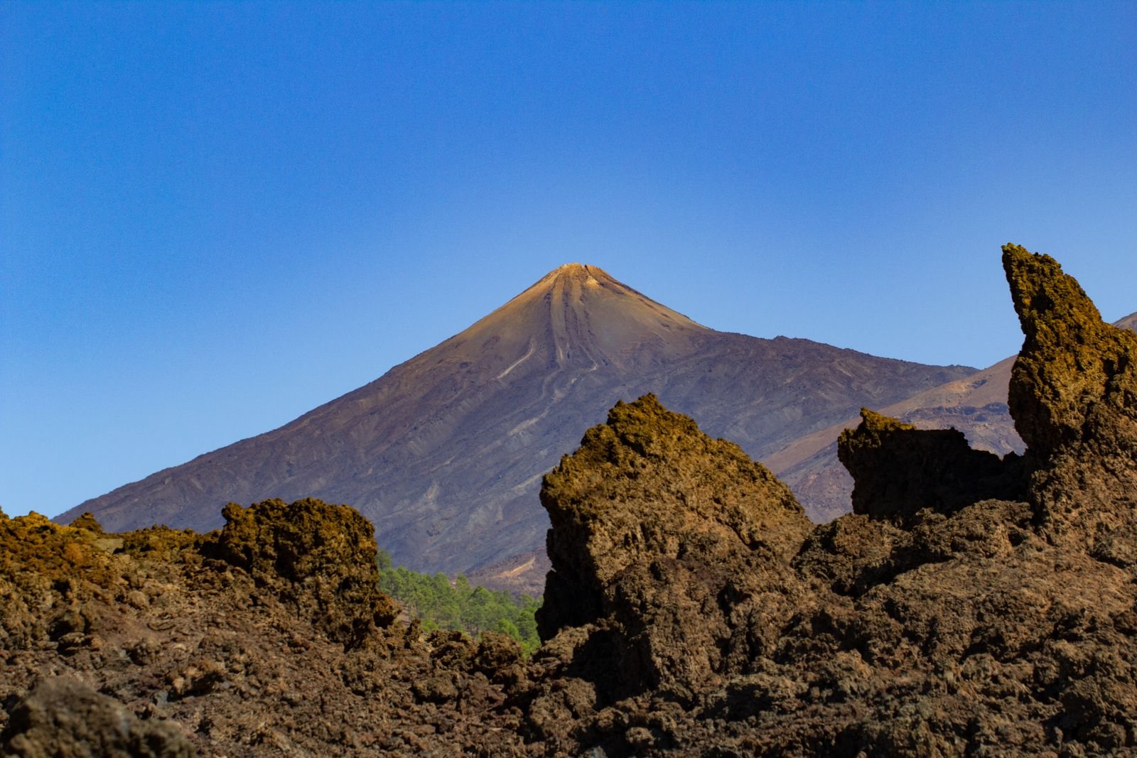 Mount Teide rising behind volcanic rock in Tenerife